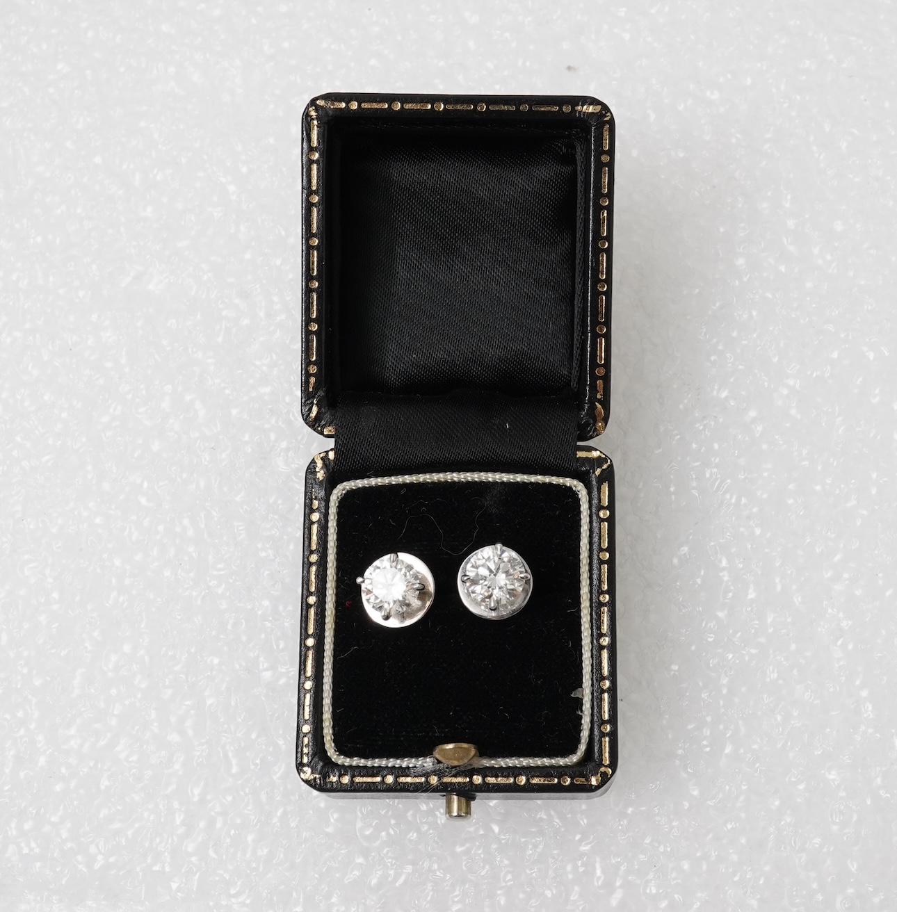 A pair of diamond stud earrings